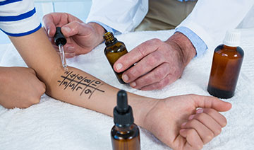 A doctor performing a skin test on a patient.